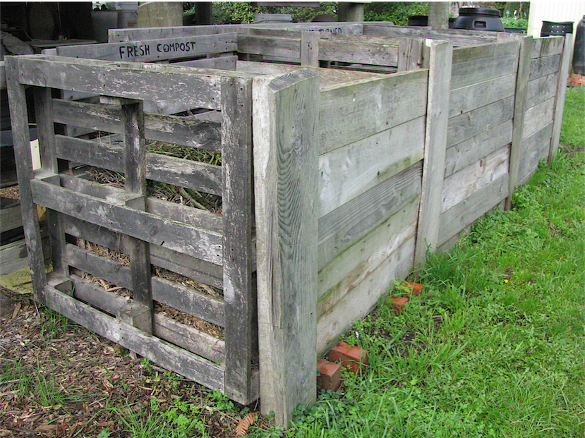 HOMEMADE COMPOST BINS MADE FROM PALLETS & EXTRA TIMBER FOR UPRIGHTS AND FROUNT PLANKS IN SLOTTED GROOVES.